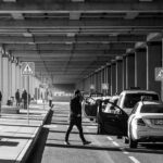 Une scène urbaine monochrome avec des piétons et des voitures