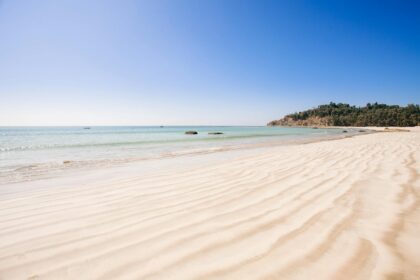 Une plage de sable avec de l'eau turquoise